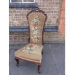 A VICTORIAN ROSEWOOD FRAMED CHAIR WITH WOOL WORK UPHOLSTERY