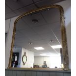 A VICTORIAN STYLE ARCHED OVERMANTEL MIRROR