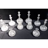 A COLLECTION OF SIMILAR CUT AND VINE ENGRAVED DECANTERS