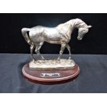A FILLED SILVER HORSE FIGURE