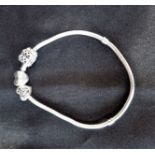 PANDORA: A SILVER BRACELET WITH TWO BEADS