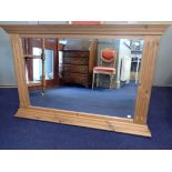 A PINE-FRAMED WALL MIRROR