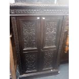 A VICTORIAN CARVED OAK CABINET