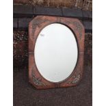 AN EARLY 20TH CENTURY COPPER-FRAMED WALL MIRROR