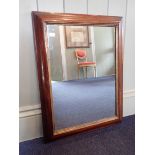 A VICTORIAN ROSEWOOD-FRAMED MIRROR