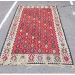 A KILIM WITH RED GROUND