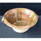 A 19TH CENTURY TWO HANDLED COUNTRY POTTERY BOWL