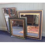 A BLACK AND GILT FRAMED MIRROR