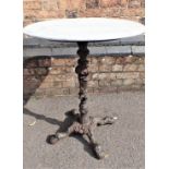 A MARBLE-TOPPED CAST IRON GARDEN TABLE