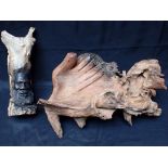 A PIECE OF KNARLED WOOD CARVED WITH A HAND