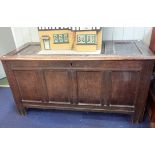 A LARGE OAK PANELLED COFFER