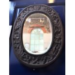 A 20TH CENTURY CARVED OAK MIRROR, REPUTEDLY THE WORK OF ITALIAN P.O.W.s