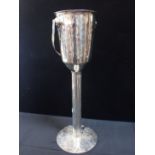 A FLOOR-STANDING CHAMPAGNE ICE BUCKET