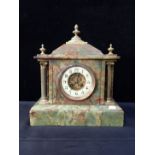 A FIGURED ONYX MANTEL CLOCK