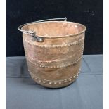 A COPPER LOG BIN WITH IRON HANDLE