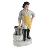 A VICTORIAN STAFFORDSHIRE POTTERY FIGURE OF A BLACKSMITH