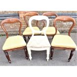 A SET OF FOUR VICTORIAN WALNUT BALLOON BACK CHAIRS