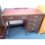 AN EDWARDIAN OAK DESK, FITTED WITH FOUR DRAWERS