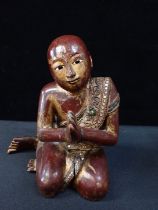 A 19TH CENTURY CARVED WOOD SCHOLAR