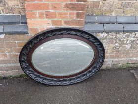 AN OVAL WALL MIRROR, WITH ACANTHUS MOULDED FRAME
