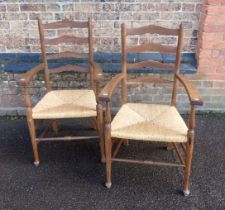 A PAIR OF EDWARDIAN ASH AND BEECH LADDER BACK ARMCHAIRS