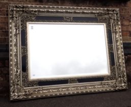 A LARGE ROCOCO STYLE WALL MIRROR