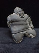AN INUIT STONE CARVING OF A FISHERMAN