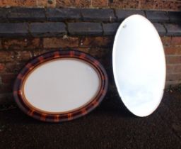 A 1920s GRAINED WOOD EFFECT OVAL MIRROR FRAME