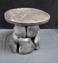 A WOODEN STOOL OF PEBBLE FORM