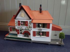 A RESTORED AND FURNISHED COTTAGE STYLE DOLLS HOUSE