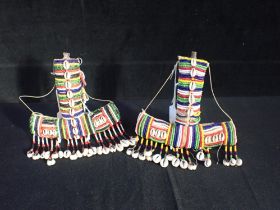 A PAIR OF AFRICAN COWRIE SHELL AND BEADWORK ANCHOR SHAPED FLASKS