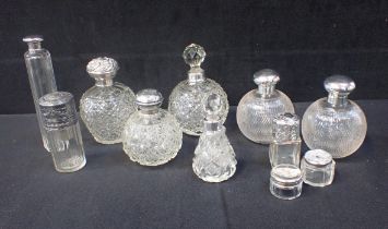 A PAIR OF SILVER MOUNTED CUT GLASS PERFUME BOTTLES