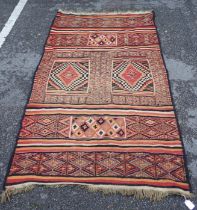 A FLAT-WEAVE RUG, PURCHASED IN THE CAMEROONS