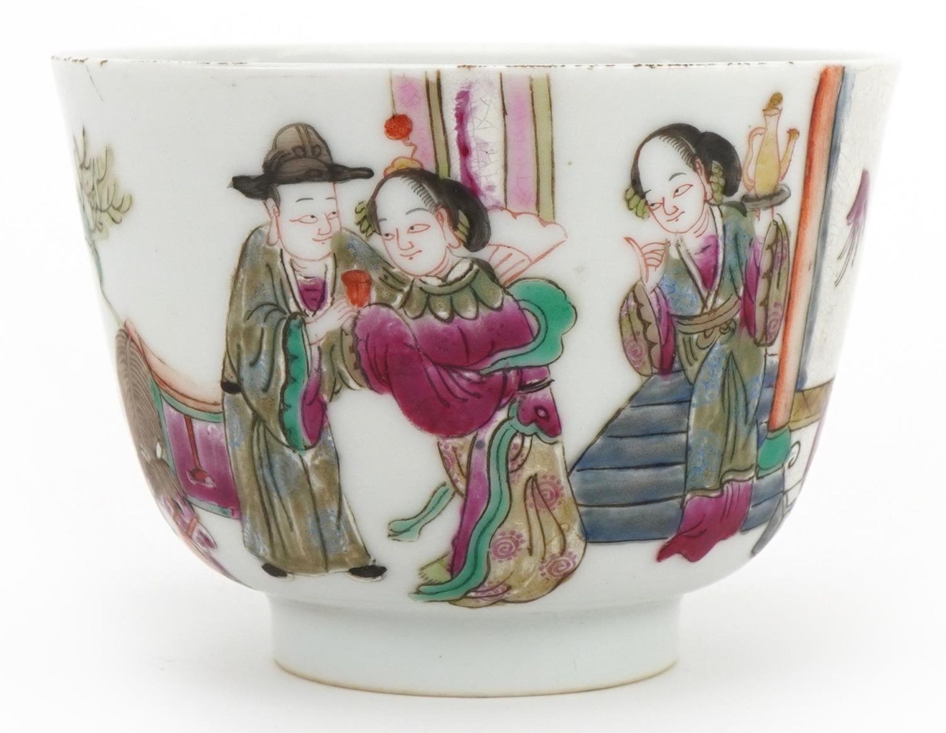 Chinese porcelain bowl hand painted in the famille rose palette with figures in a palace setting,