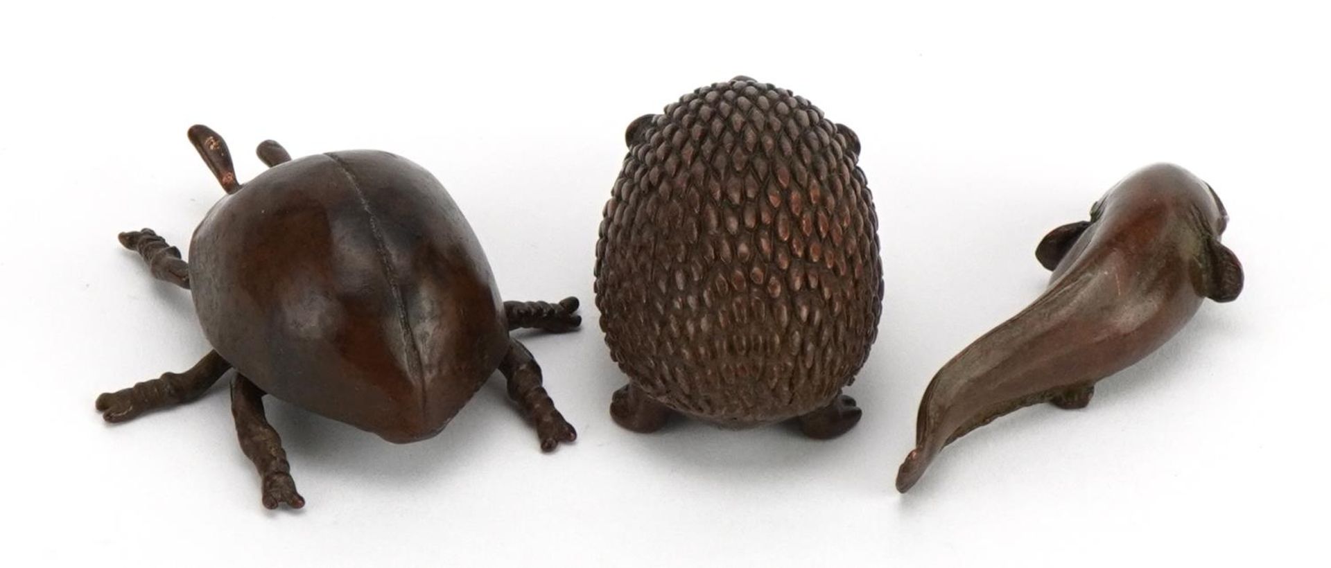 Three Japanese patinated bronze animals comprising hedgehog, beetle and fish, each with impressed - Image 2 of 4