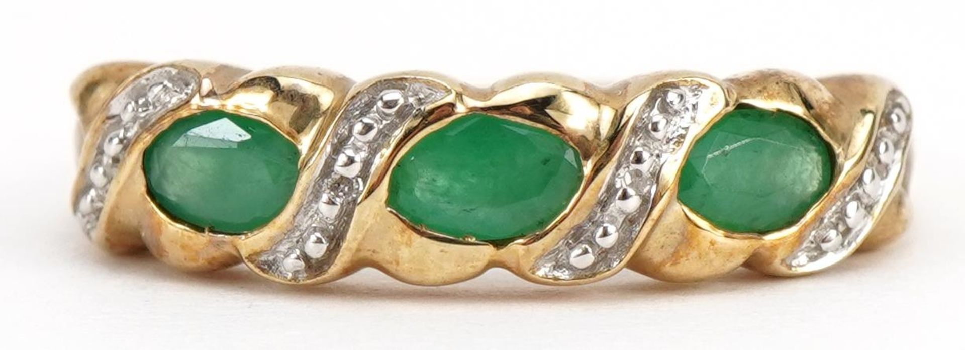 9ct gold emerald and diamond crossover ring, size P, 2.1g