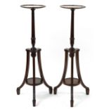Pair of mahogany tripod jardiniere stands with under tiers, each 106cm high