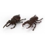 Two Japanese patinated bronze beetles including stag beetle, each with impressed marks, the