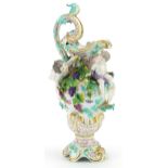 Manner of Dresden, continental porcelain floral encrusted ewer surmounted with two Putti,