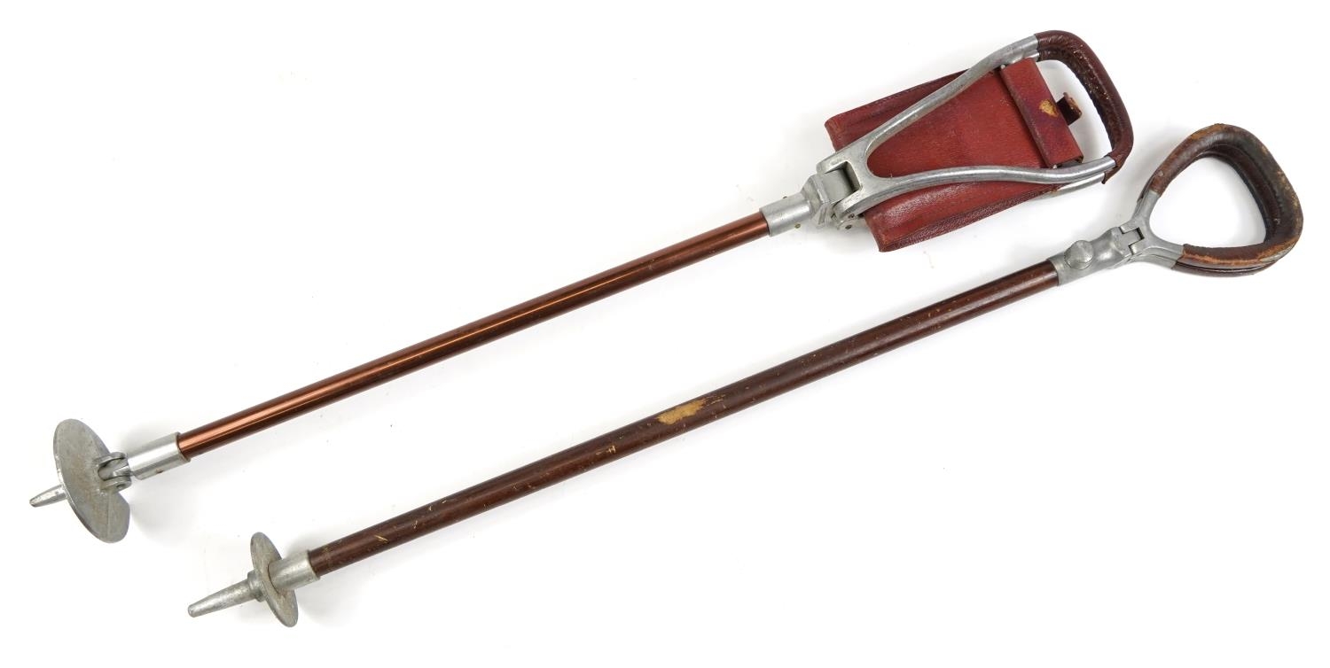 Two vintage leather shooting sticks, 81cm in length