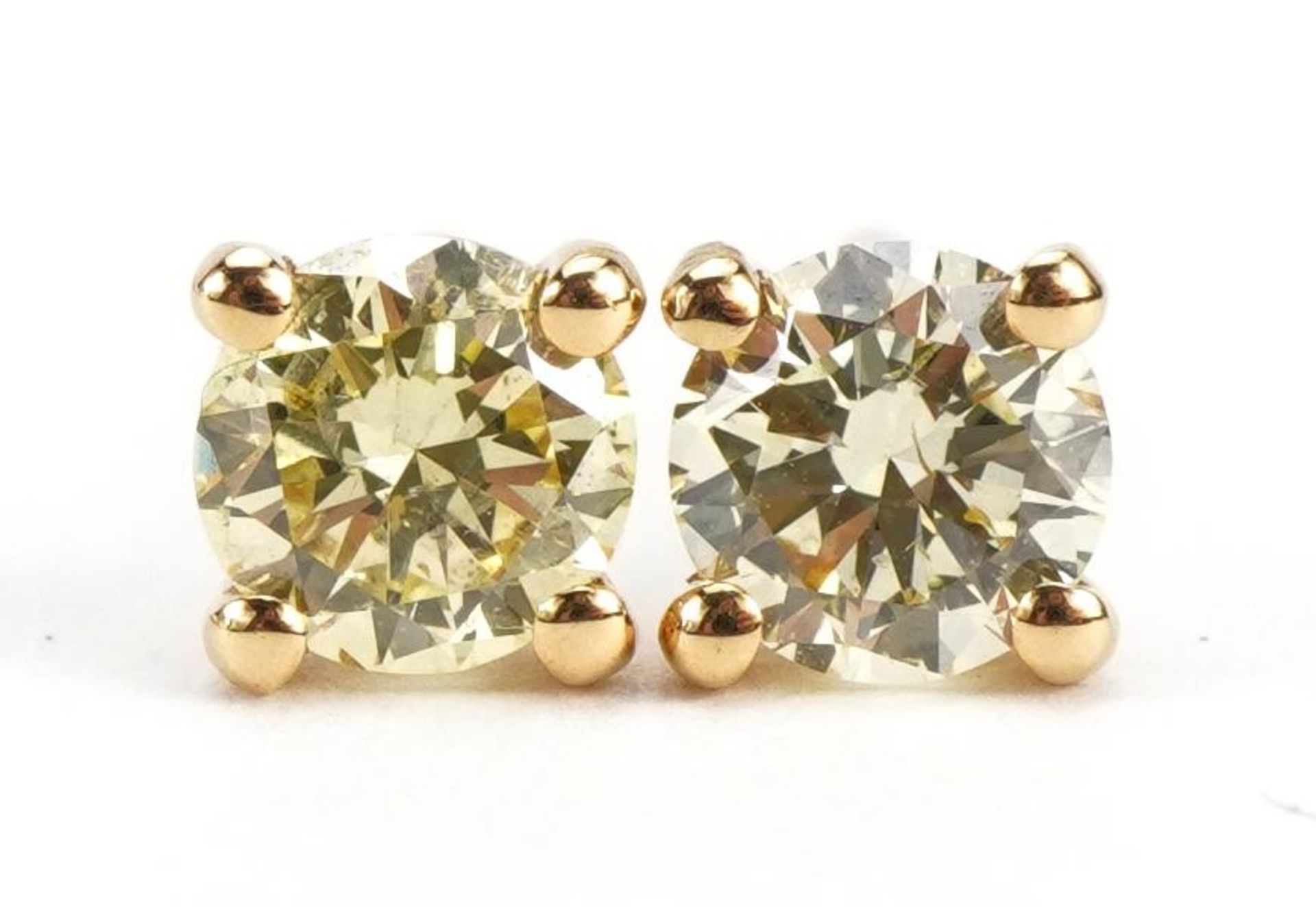 Pair of 18ct gold diamond solitaire stud earrings, total diamond weight approximately 0.61 carat,