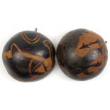 Pair of tribal interest coco de mer bum nut bowls carved with sea creatures, each approximately 23cm