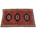 Rectangular Turkish red and blue ground rug with all over geometric design, 180cm 116cm