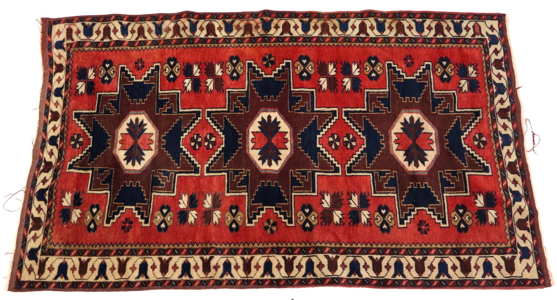 Rectangular Turkish red and blue ground rug with all over geometric design, 180cm 116cm