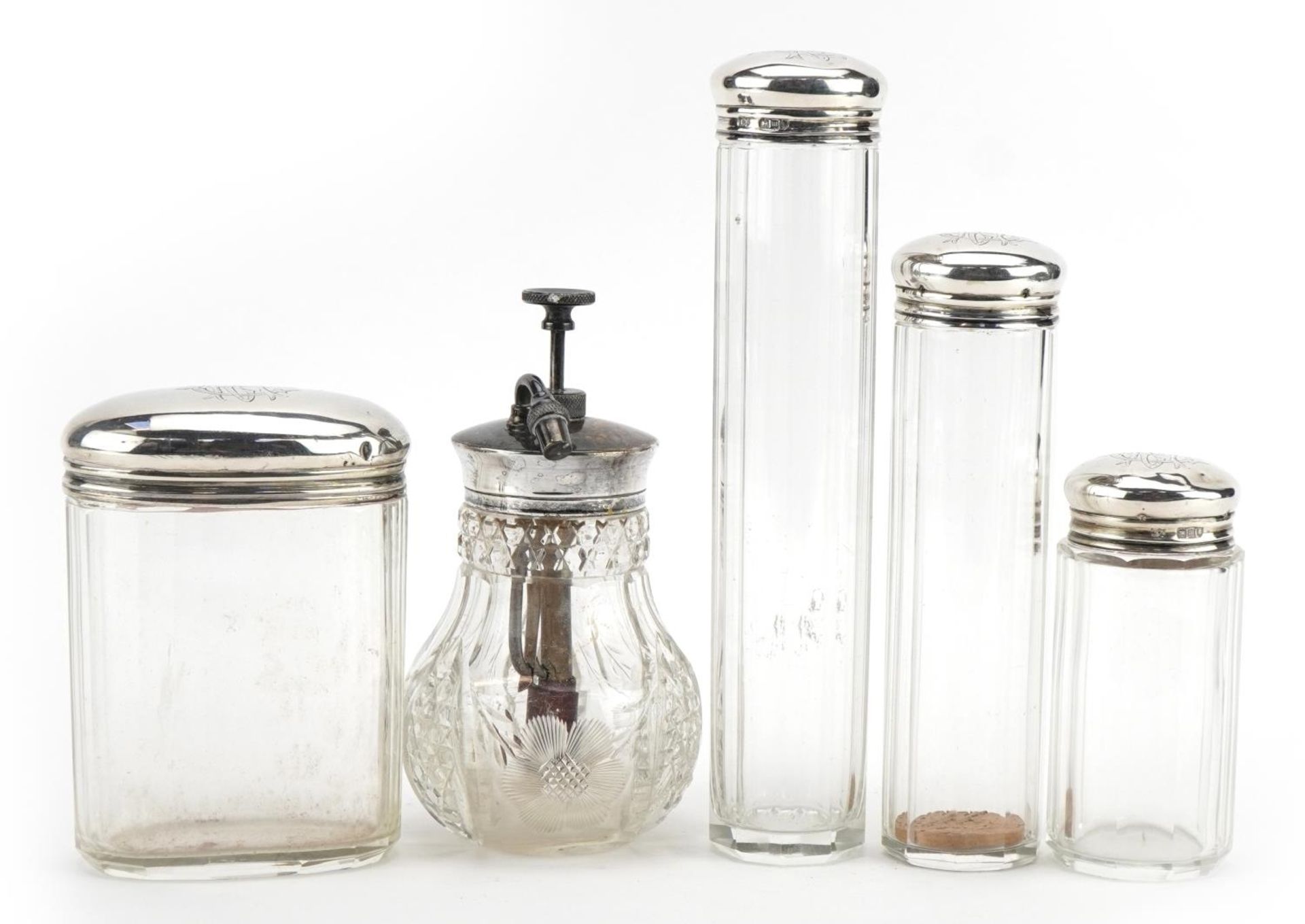 Four cut glass jars with silver lids and a Victorian cut glass atomiser with silver coloured metal