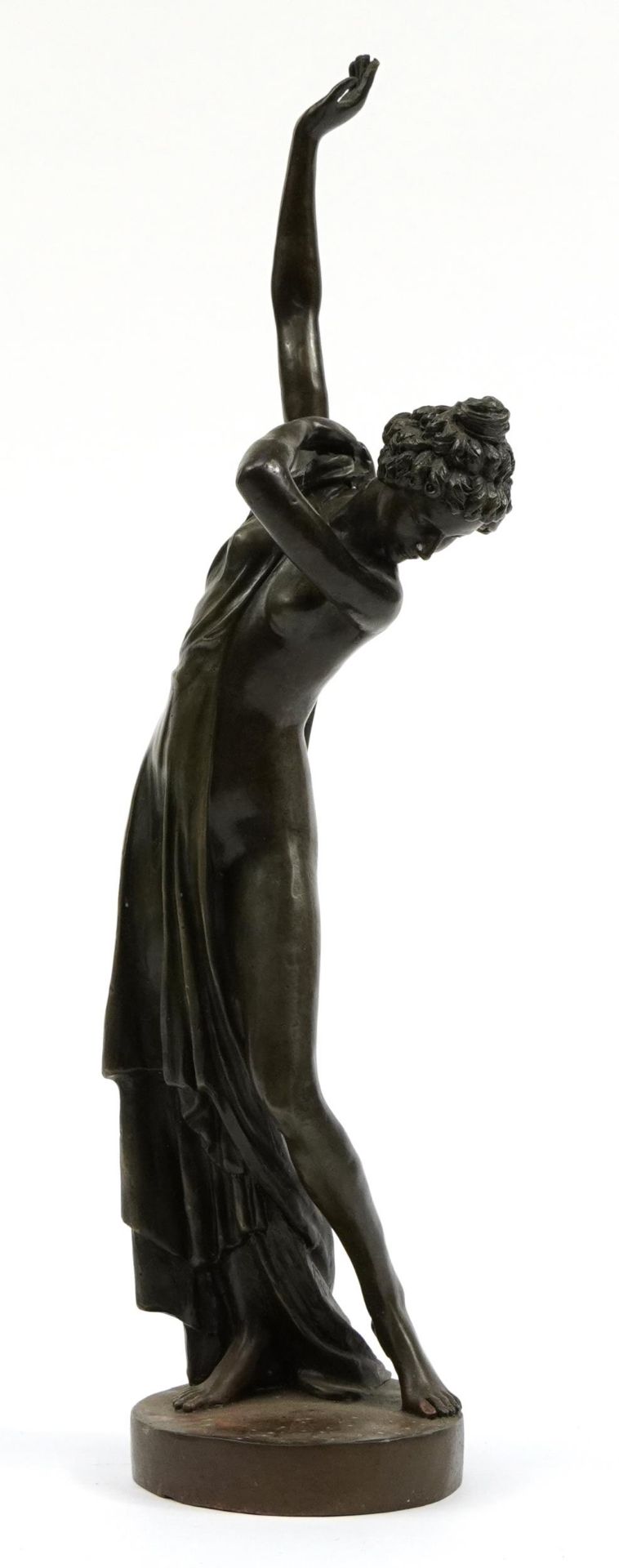 Patinated bronze study of a semi nude Art Deco female dressing, 48cm high