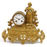 French gilt metal striking mantle clock mounted with a female in a dress, the enamelled dial