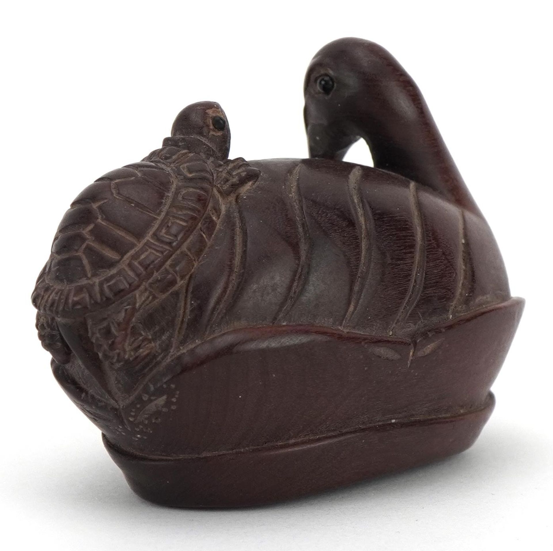 Japanese carved wood netsuke of a bird and tortoise, mother of pearl insert to the base, 5.5cm wide - Image 2 of 4