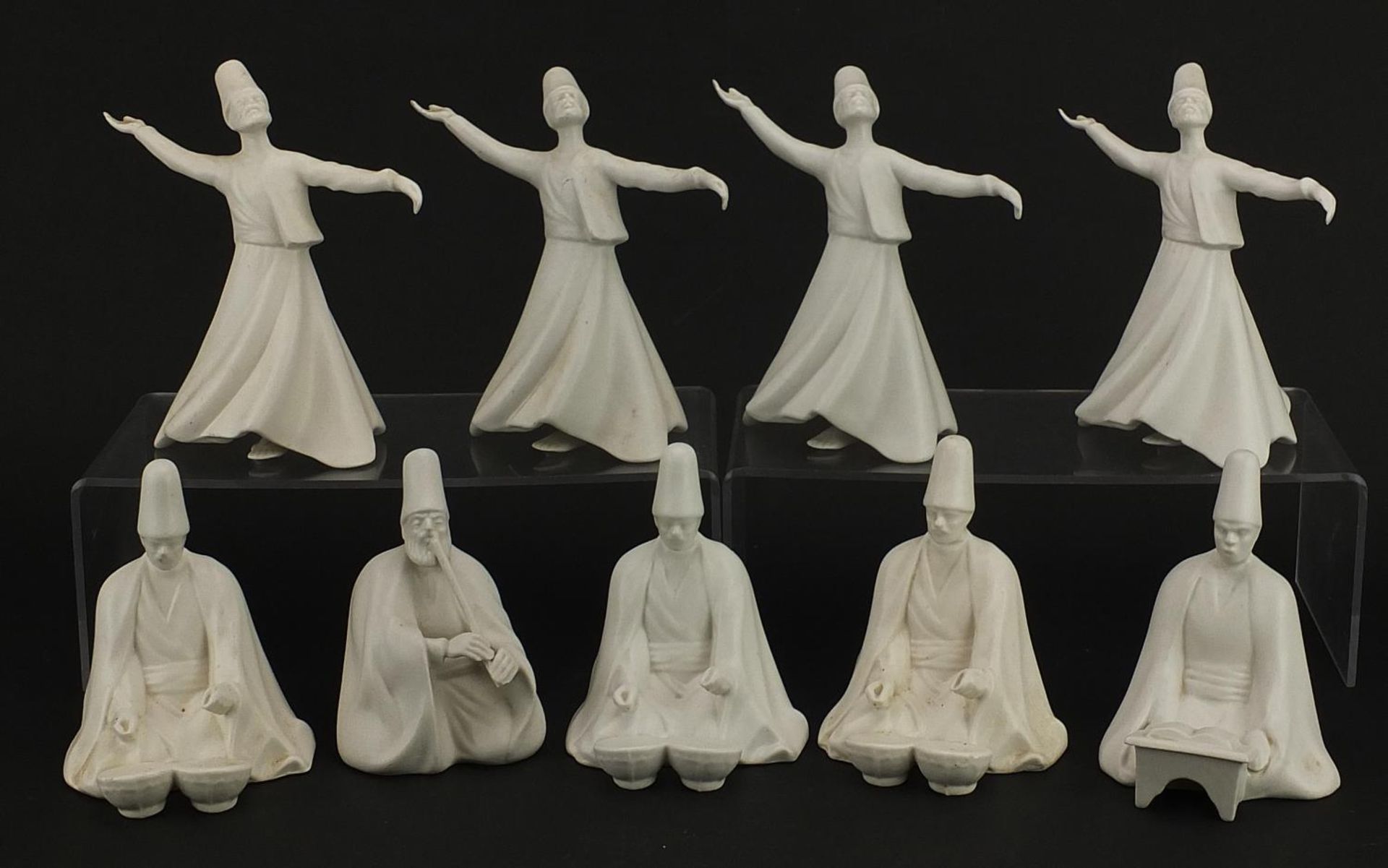 Nine Turkish porcelain whirling dervish figures, each with painted factory marks to the bases, the