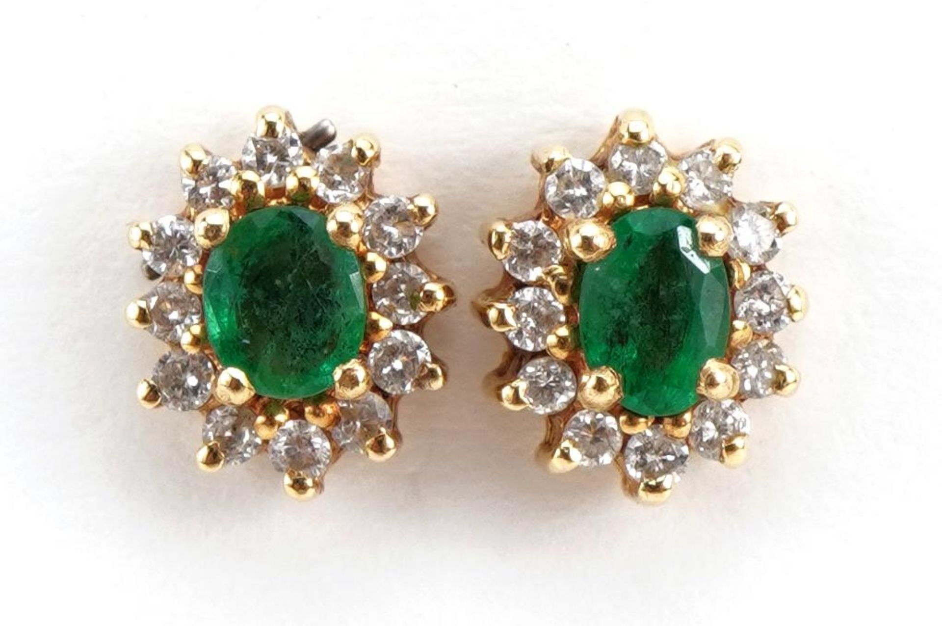 Pair of unmarked gold emerald and diamond cluster stud earrings, the backs marked 750, 8mm high, 2.